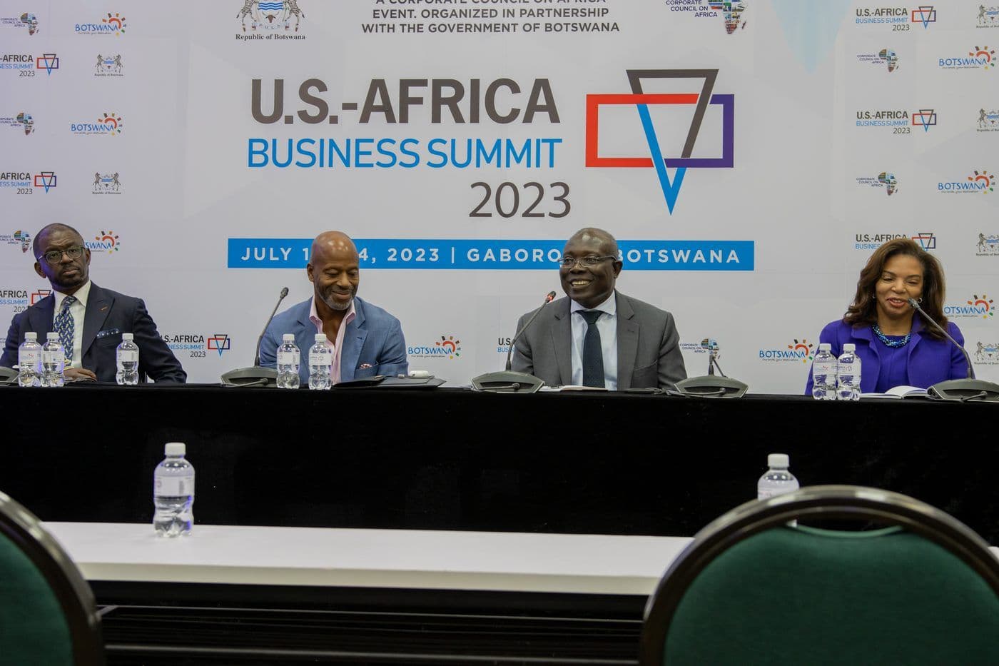 A panel on stage beneath a screen announcing the 2023 U.S.-Africa Business Summit.